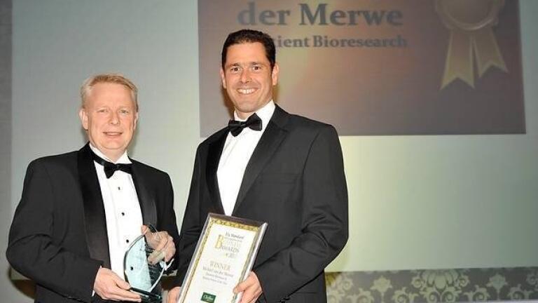Dr Michael van der Merwe, Associate Director of Business Development being presented with the Business Person of the Year by Mark Peck, Director from Cheffins.

