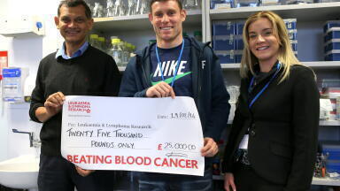 Footballer visits childhood cancer research project