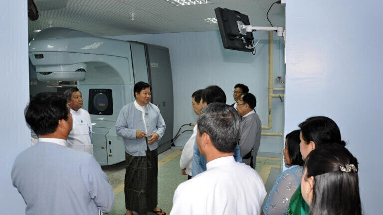 Prof. Dr. Pe Thet Khin, Myanmar's Minister of Health, (3rd from left) talks with guests about the new linear accelerator from Varian Medical Systems recently installed at the Yangon General Hospital.
