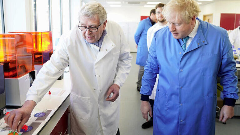Prime Minister Boris Johnson is guided around Mologic's laboratory facilities by co-founder and chief scientific officer, Professor Paul Davies