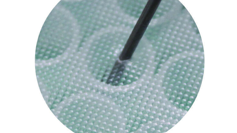 Close-up image of needle piercing seal.
