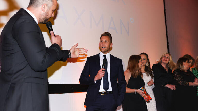 Richard Paxman (second left) receives the 2022 Medilink Award  for Outstanding Achievement on behalf of Paxman, a company specialising in scalp cooling and cryotherapy.