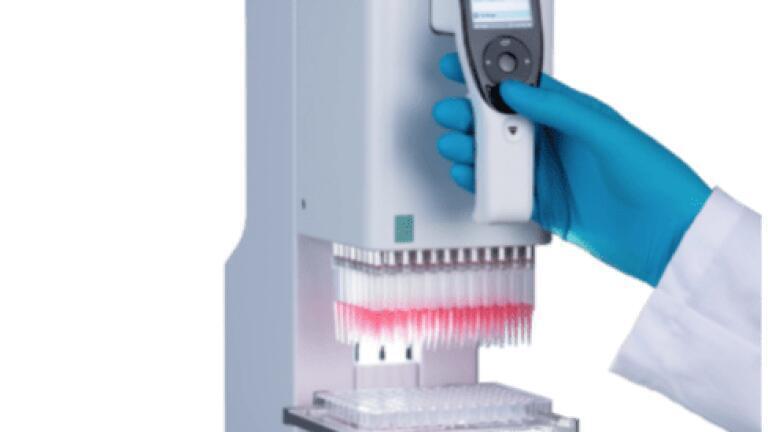 Scientist operating the handheld MINI 96 electronic pipette