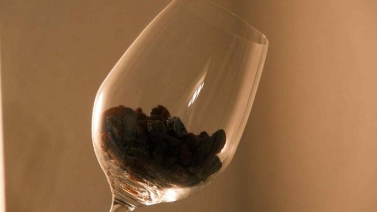 Sun-dried raisins soaked in water will naturally ferment into wine. Credit: KyotoU