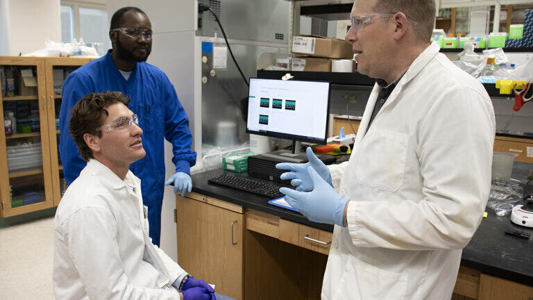 [From left] Utah State University biochemists Kadin Crosby, Bamidele Filani and Ryan Jackson report newly discovered functions of the bacterial immune system CRISPR-Cas12a3 in the Jan. 7, 2026 issue of the journal ‘Nature.’ The findings could lead to more efficient and safer rapid diagnostic tools for detecting COVID, influenza and RSV in human patients. Credit: M. Muffoletto